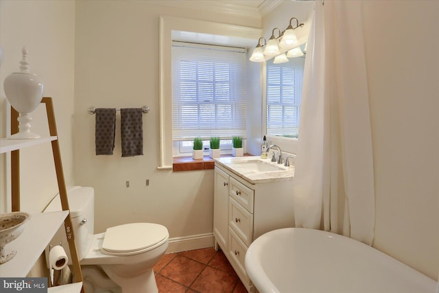 bathroom with baseboards, toilet, a soaking tub, tile patterned flooring, and vanity