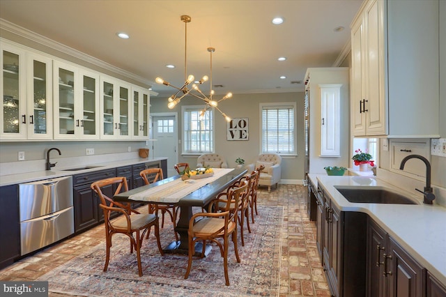 kitchen with brick floor, recessed lighting, a sink, light countertops, and crown molding