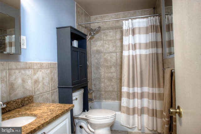 bathroom featuring toilet, tile walls, vanity, and shower / tub combo with curtain