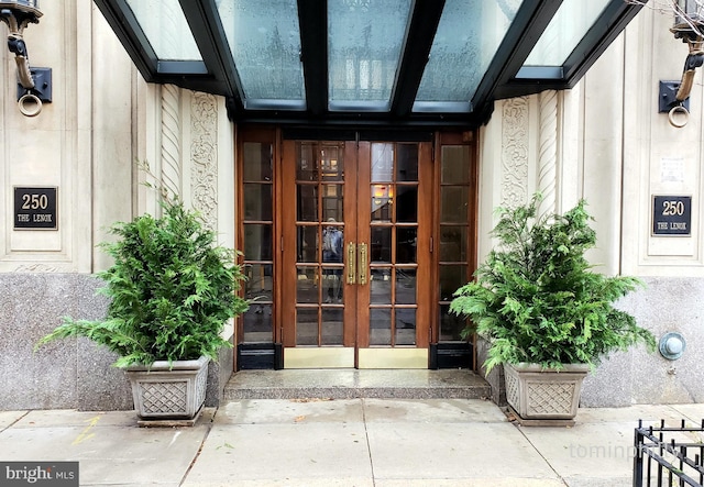 property entrance with stucco siding and french doors