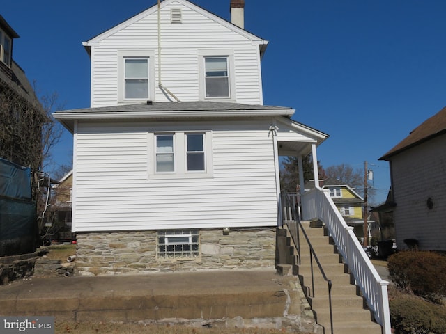 exterior space with stairway and a chimney