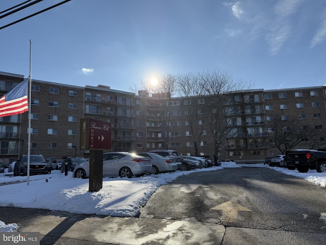 snow covered building featuring uncovered parking