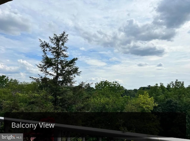 view of landscape with a forest view