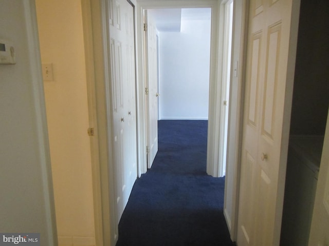 hall with dark carpet