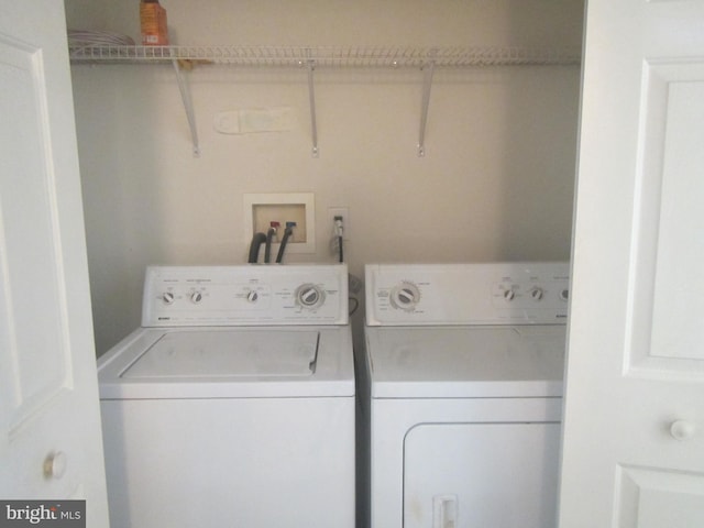 clothes washing area with laundry area and washer and clothes dryer