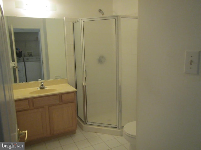 full bath featuring toilet, vanity, a shower stall, tile patterned floors, and washer / dryer