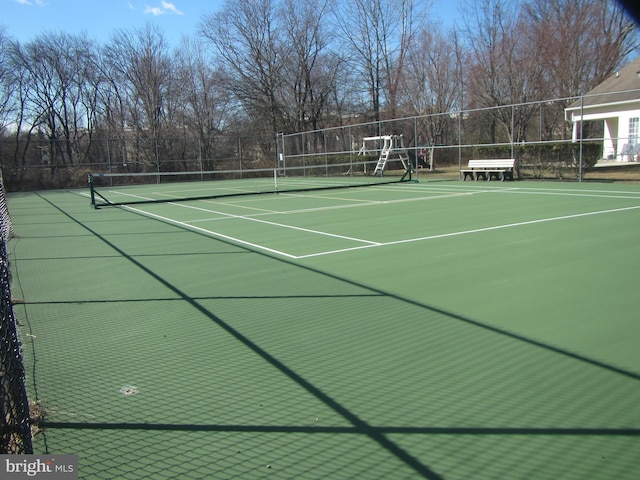 view of tennis court with fence