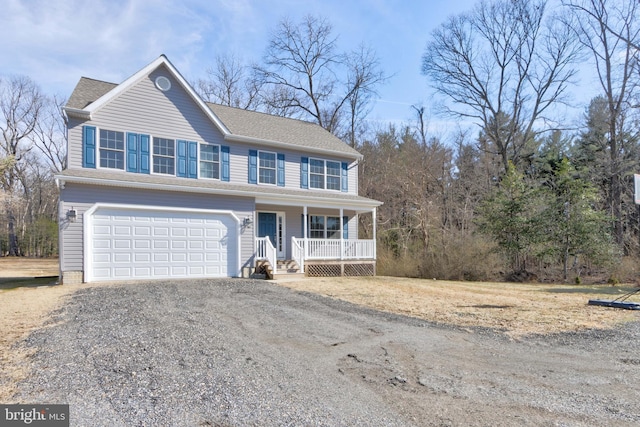 view of front of property with driveway, a garage, and a porch