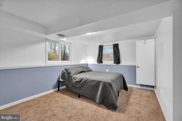 bedroom with carpet, visible vents, and baseboards