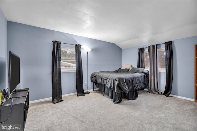 carpeted bedroom featuring vaulted ceiling and baseboards