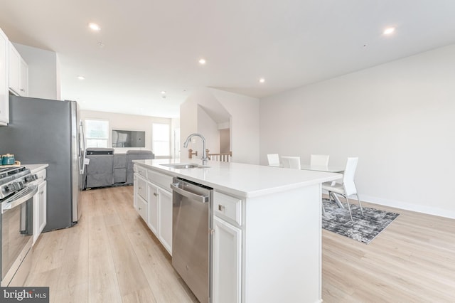 153 Glory Maple Ln, Downingtown, PA 19335 - kitchen with an island with sink, a sink, open floor plan, white cabinetry, and appliances with stainless steel finishes