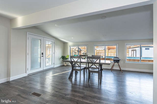 dining room featuring visible vents, baseboards, dark wood finished floors, lofted ceiling, and french doors