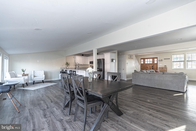 dining area with stairway, dark wood-type flooring, and baseboards