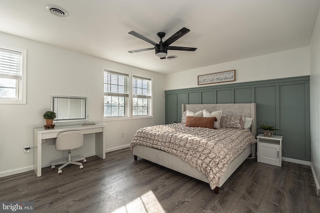 bedroom with ceiling fan, visible vents, baseboards, and dark wood-style floors