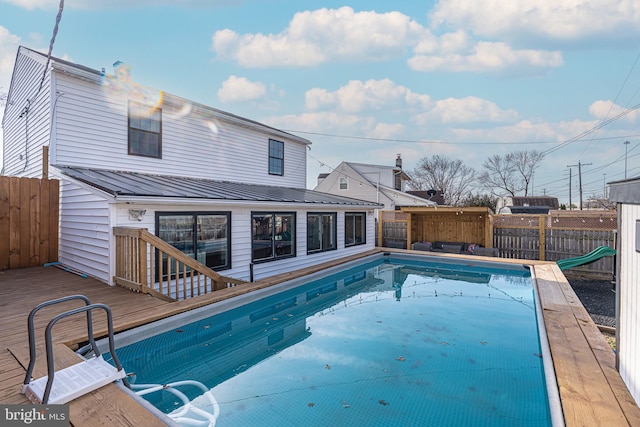 view of pool with a deck, a fenced in pool, and a fenced backyard