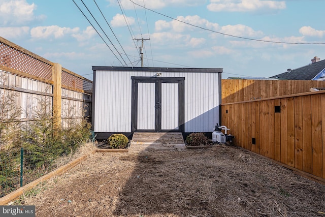 view of shed with a fenced backyard