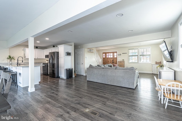 living area with visible vents, baseboards, stairway, recessed lighting, and dark wood-style floors