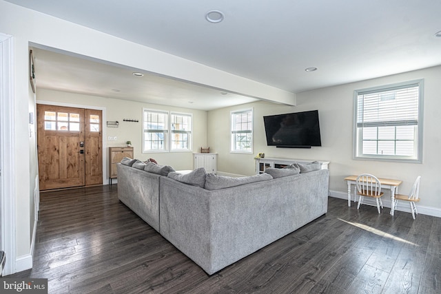 living area with dark wood-style floors, beam ceiling, recessed lighting, and baseboards