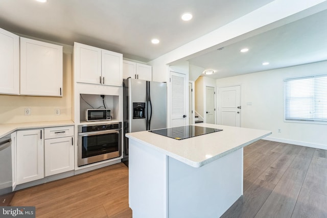 kitchen featuring light countertops, appliances with stainless steel finishes, and light wood-type flooring