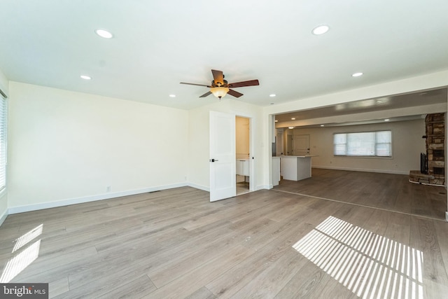 unfurnished living room featuring light wood-style flooring, recessed lighting, baseboards, and ceiling fan
