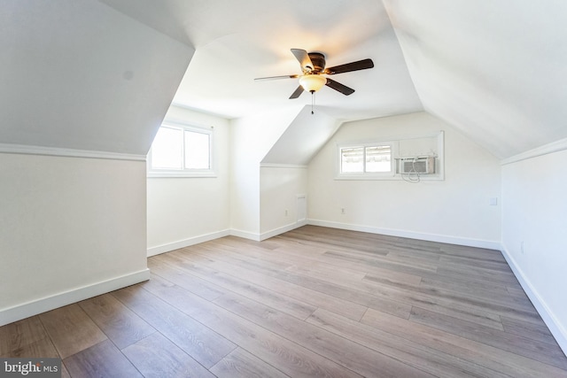 bonus room featuring baseboards, lofted ceiling, ceiling fan, and light wood finished floors
