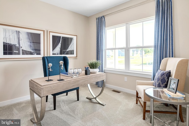 carpeted office featuring visible vents and baseboards