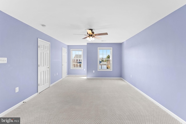 spare room with ceiling fan, baseboards, and carpet flooring