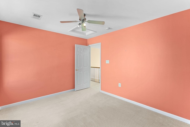 unfurnished room featuring baseboards, a ceiling fan, visible vents, and light colored carpet