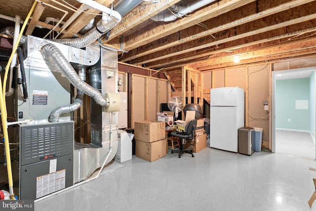 unfinished basement featuring freestanding refrigerator