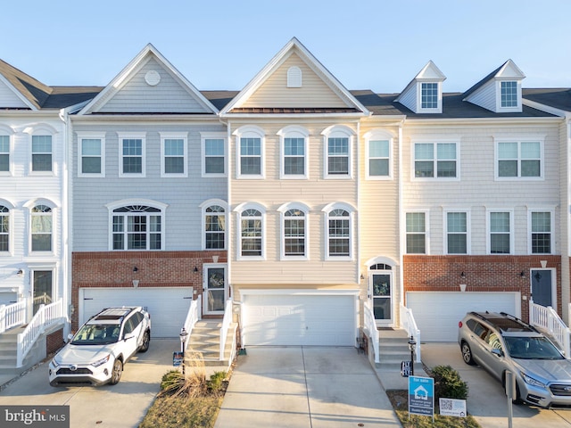 view of property featuring a garage and driveway