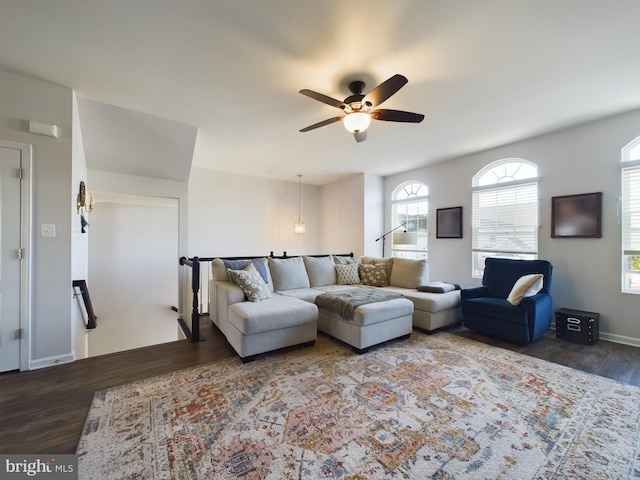 living room featuring ceiling fan, wood finished floors, and baseboards