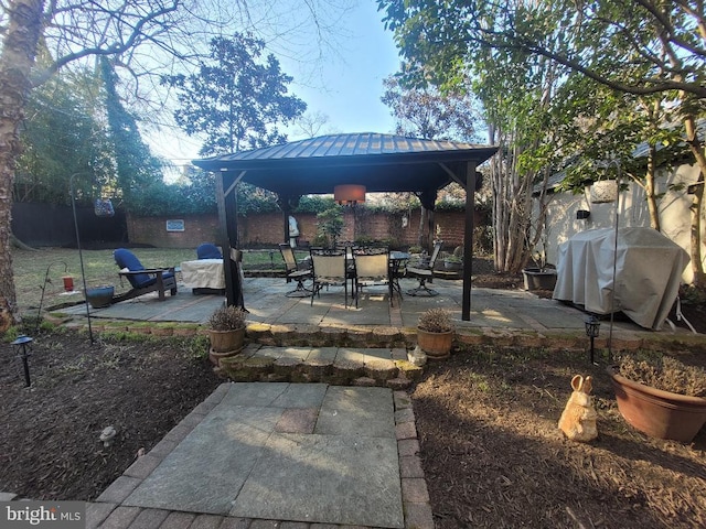 view of patio / terrace featuring a gazebo, grilling area, and a fenced backyard