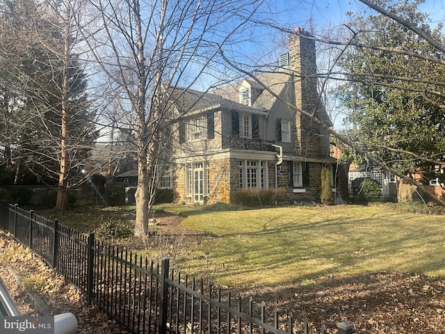 view of home's exterior with a yard, a chimney, and fence