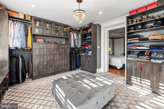 spacious closet with a chandelier