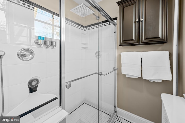 full bath featuring baseboards and a stall shower