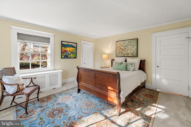 carpeted bedroom featuring radiator heating unit and baseboards