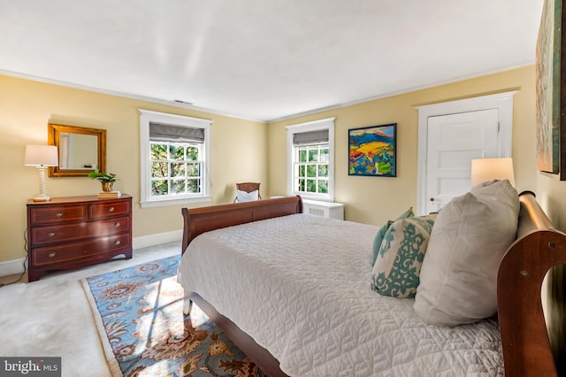 carpeted bedroom featuring visible vents and baseboards