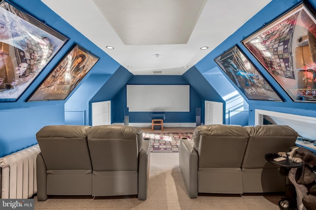 carpeted home theater with recessed lighting, radiator heating unit, and vaulted ceiling