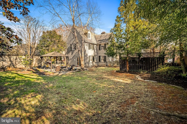 view of yard featuring a gazebo, a patio, and a fenced backyard