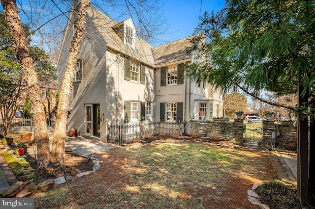 back of house featuring a patio area, stucco siding, a chimney, and fence