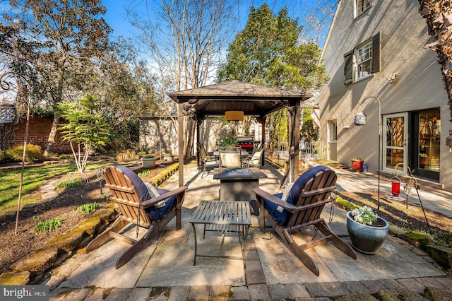 view of patio featuring a gazebo and a fire pit