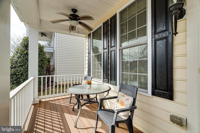 wooden terrace with ceiling fan and a porch