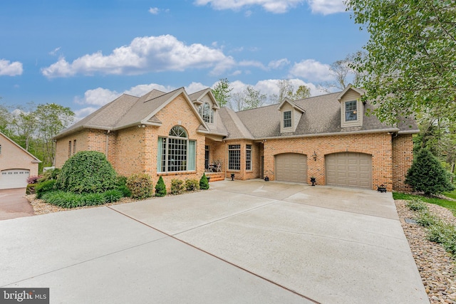 view of front facade featuring driveway, brick siding, roof with shingles, and an attached garage