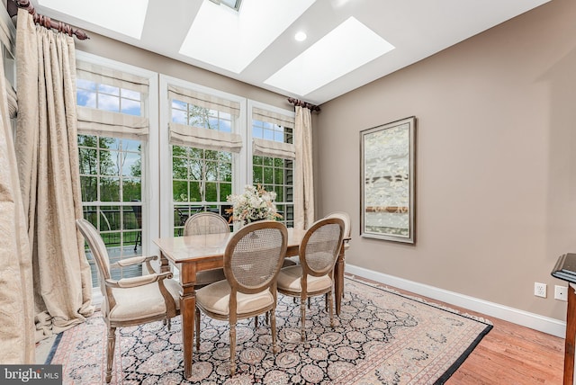 dining area with plenty of natural light, a skylight, and baseboards