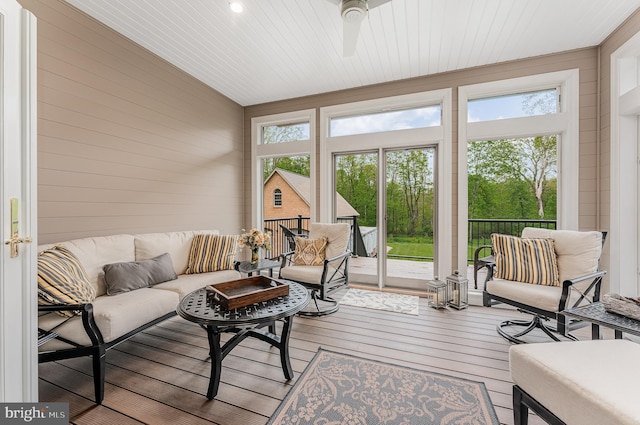 sunroom / solarium with wooden ceiling, plenty of natural light, and a ceiling fan