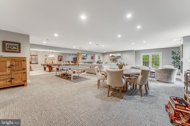 dining room with recessed lighting and light colored carpet