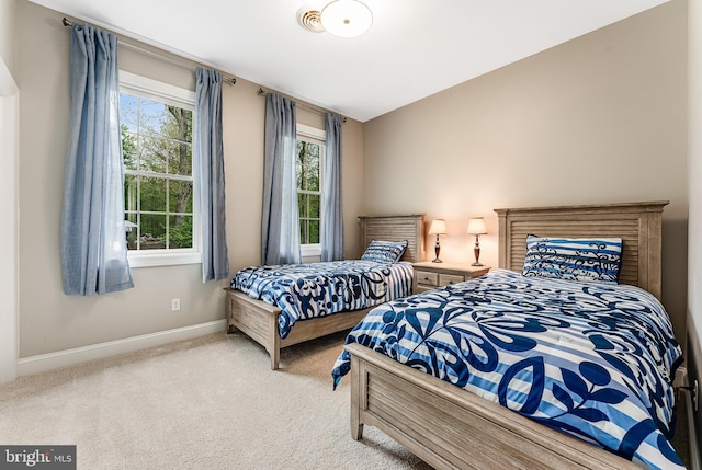 bedroom with carpet flooring and baseboards