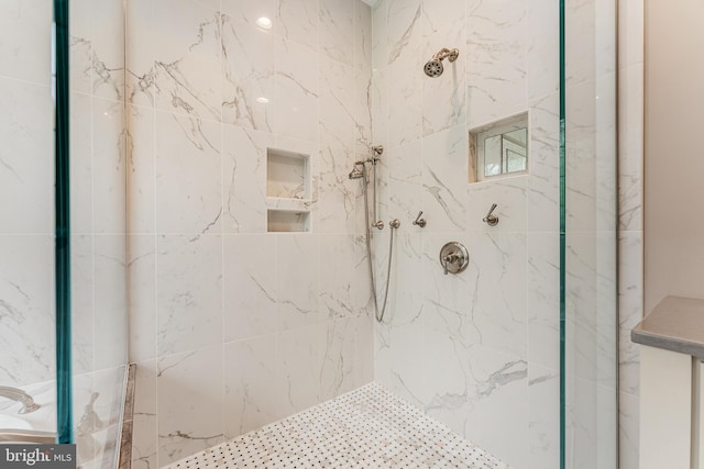 bathroom with a marble finish shower