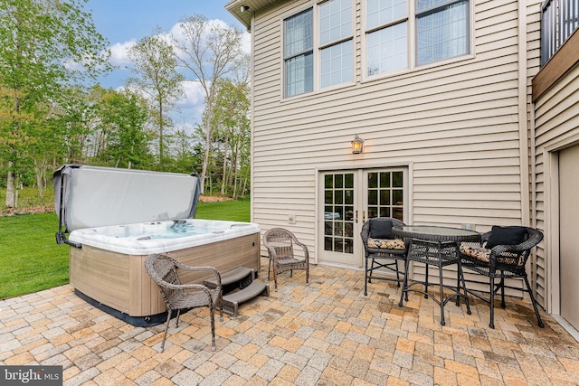 view of patio / terrace with french doors and a hot tub