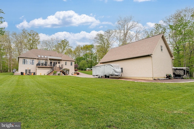 rear view of house with a lawn, a patio, stairs, and a deck